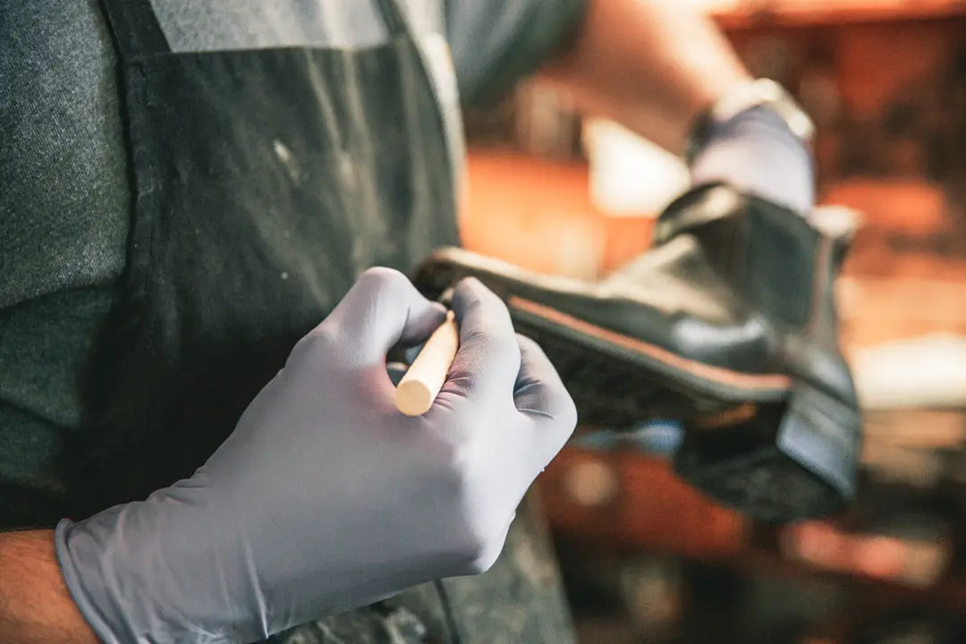 Craftsman at Wohlford finishing a made to order boot.