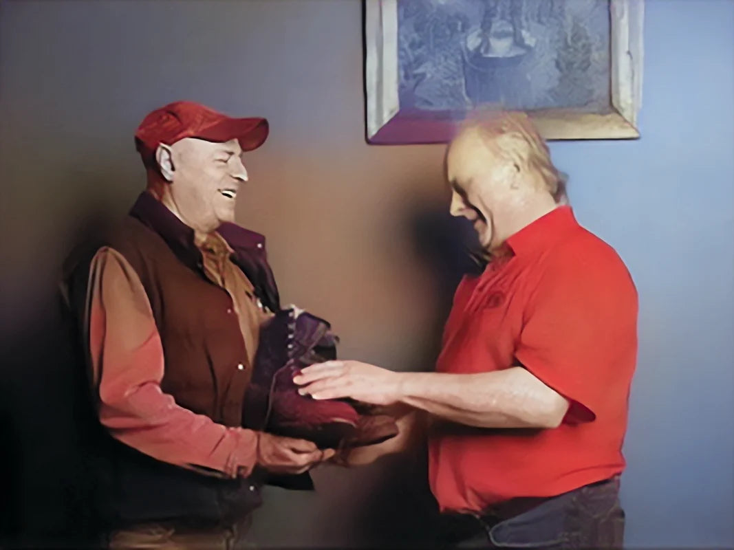 Ray Wohlford presenting boots to a satisfied customer. ( Image Restored )